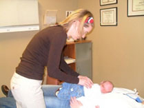 Baby Receiving An Adjustment by a Chiropractor