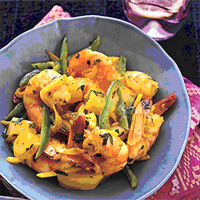 Curried Shrimp served in a blue bowl with vegetables