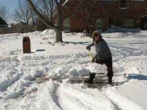 Man in the snow shoveling